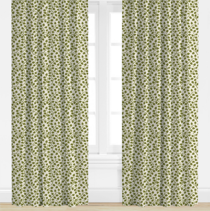 Green patterned curtains on a white window with a white wall background