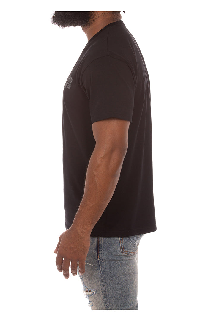 Model wearing Billionaire Boy's Club Black BB Club SS Knit for a casual, street-style look