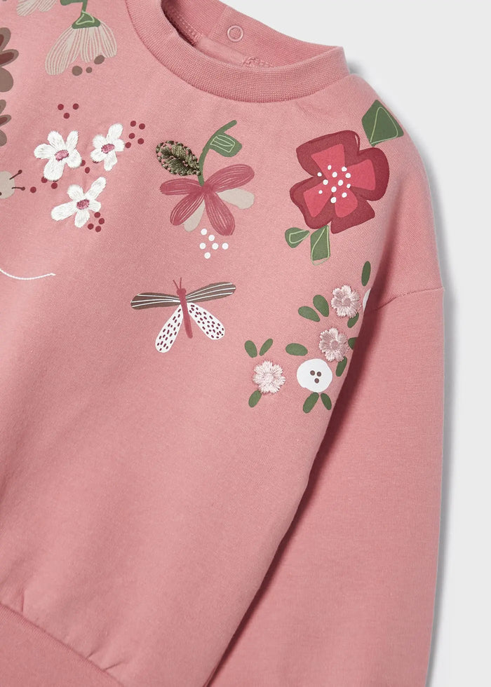 Closeup of Mayoral baby girl floral sweatshirt showing embroidered flowers on Rubor cotton fabric.