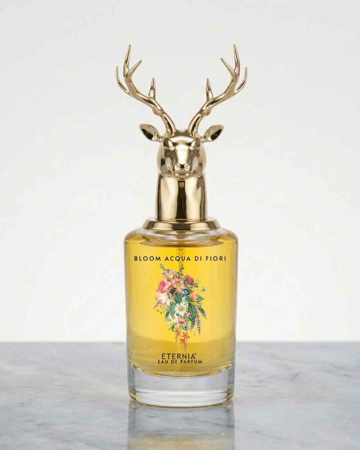 Eternia eau de parfum bottle with gold deer-antler cap and yellow floral liquid