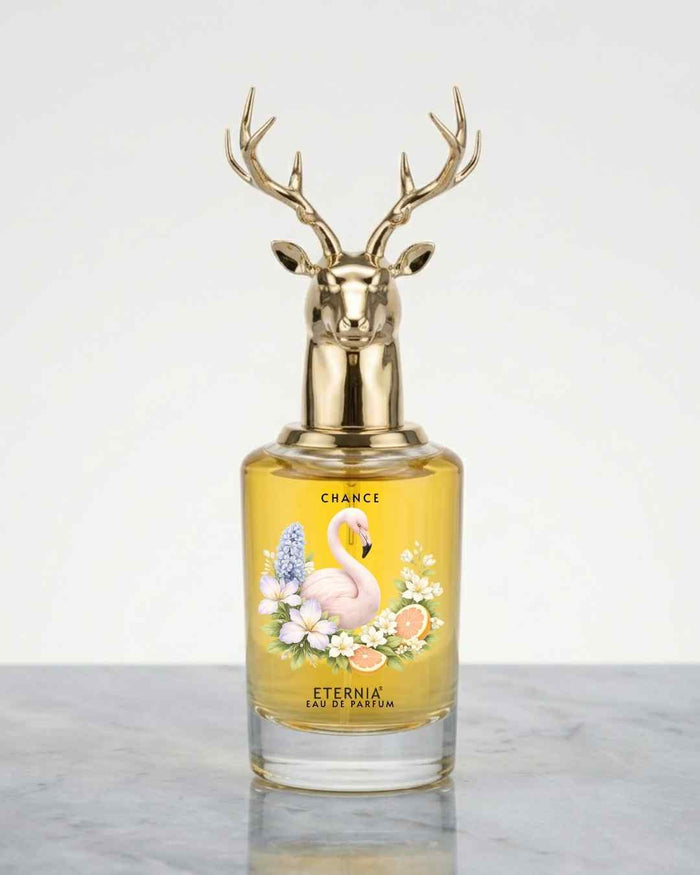 Floral perfume bottle with deer antler gold cap and amber glass, label reads 'Chance'.