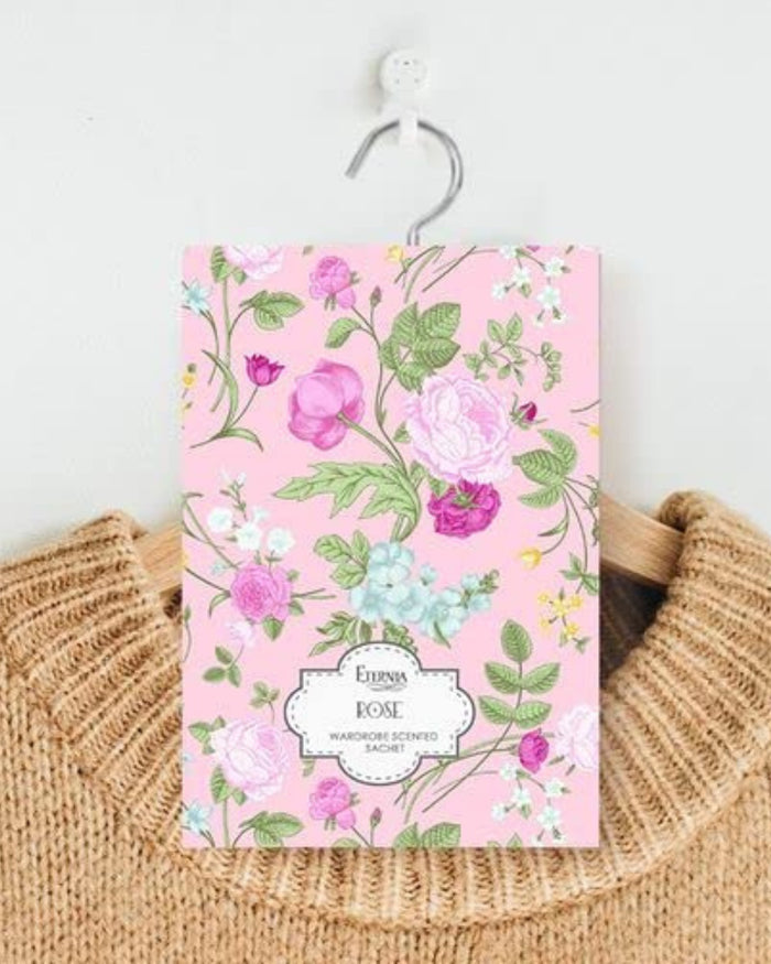 Rose-scented wardrobe fragrance sachet with pink floral pattern and hanging string