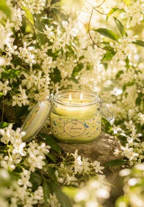 Glass jar candle with jasmine label and lid, pale green wax, unlit