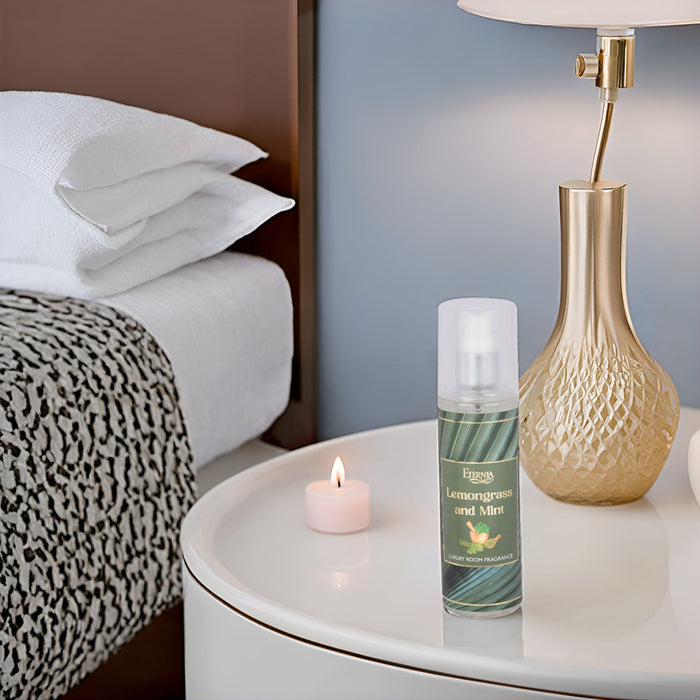 Luxury room spray bottle with white cap on a round side table beside a candle