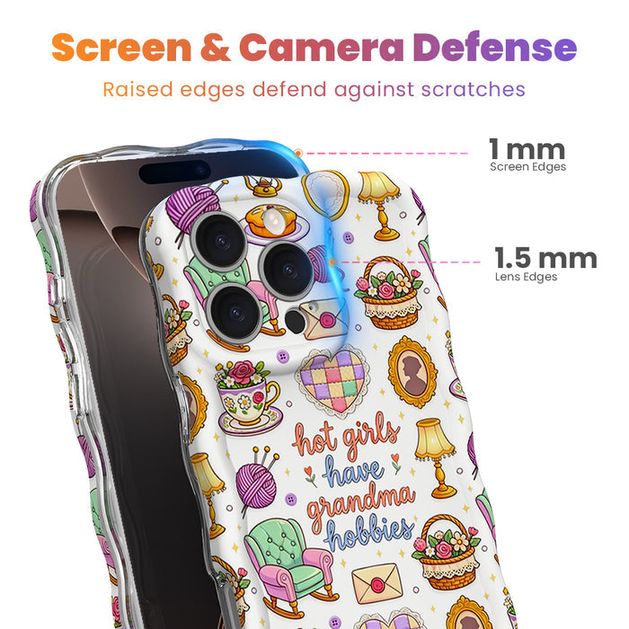Trendy wavy iPhone case featuring a whimsical grandmacore pattern of yarn, rocking chairs, teacups, and a "hot girls have grandma hobbies" quote with a high-gloss finish.