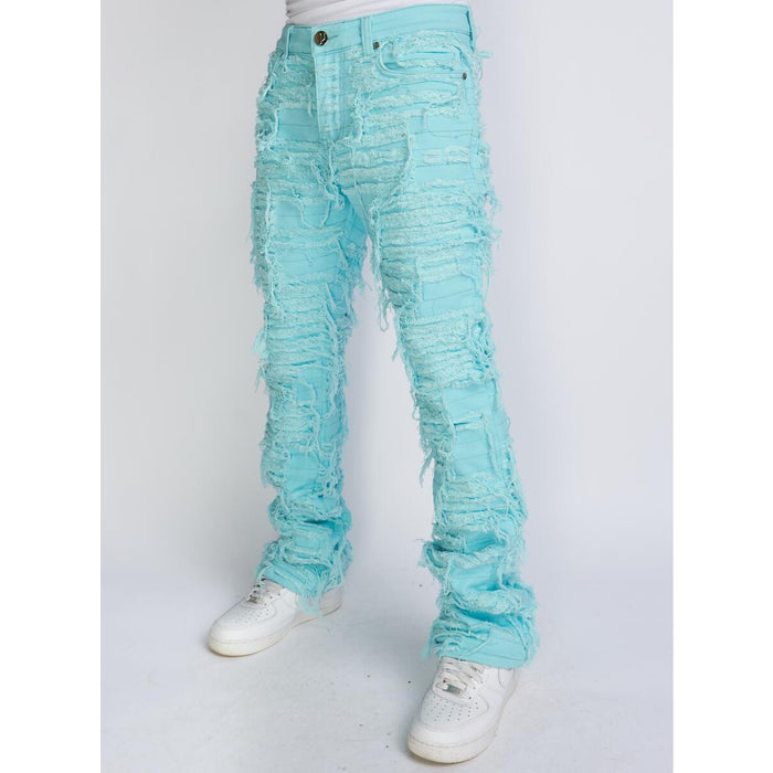 Light blue trashed distressed stacked flare jeans featuring debris503 design