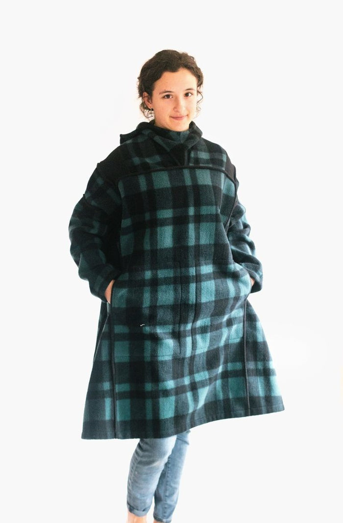 Photo of young woman standing with hands in pockets of oversized fleece Siberian Parka.
