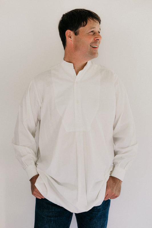 Photo of man standing wearing Victorian Shirt in front of studio backdrop.