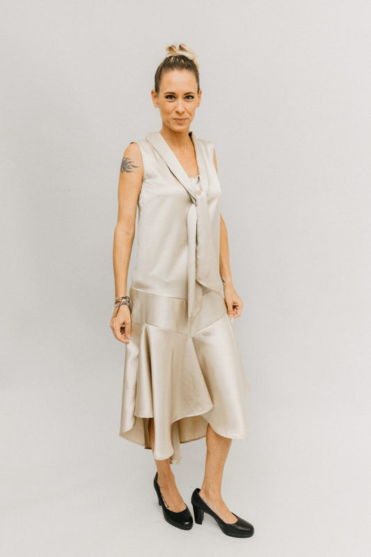 Woman standing in front of a white studio backdrop wearing  black pumps with the 237 Tango Dress with V hugging the body at the bodice.