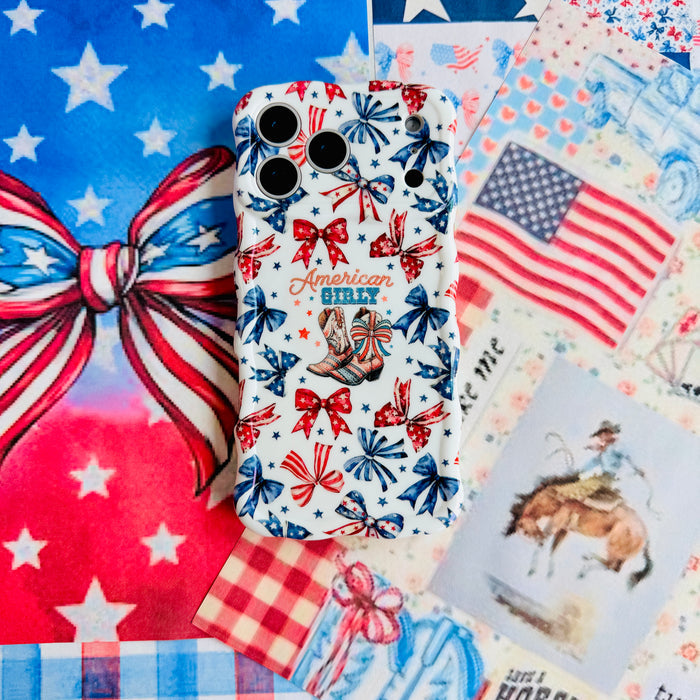 American Girly Wavy Luxe MagSafe iPhone case flat lay on a patriotic stars and stripes backdrop with an American flag and red gingham.