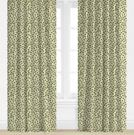 Green patterned curtains on a white window with a white wall background