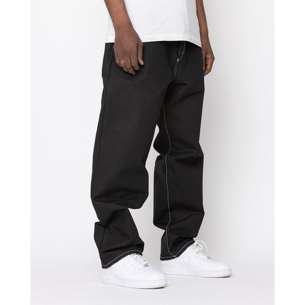 Person wearing BLKWD Relaxed XL - Felix Raw Denim jeans in a relaxed fit, showcasing the authentic dark wash and comfortable style