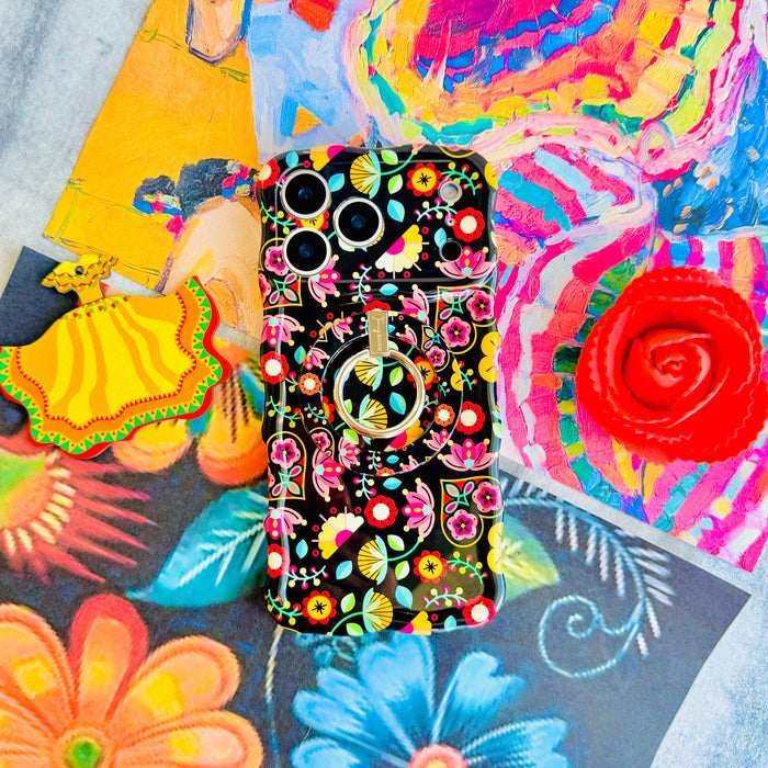 Trendy black wavy iPhone case featuring an intricate folk art botanical pattern of red flowers, magenta details, and yellow fan petals with a high-gloss finish.