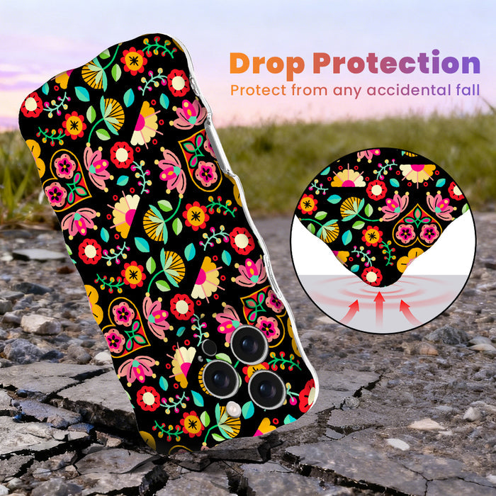 Trendy black wavy iPhone case featuring an intricate folk art botanical pattern of red flowers, magenta details, and yellow fan petals with a high-gloss finish.