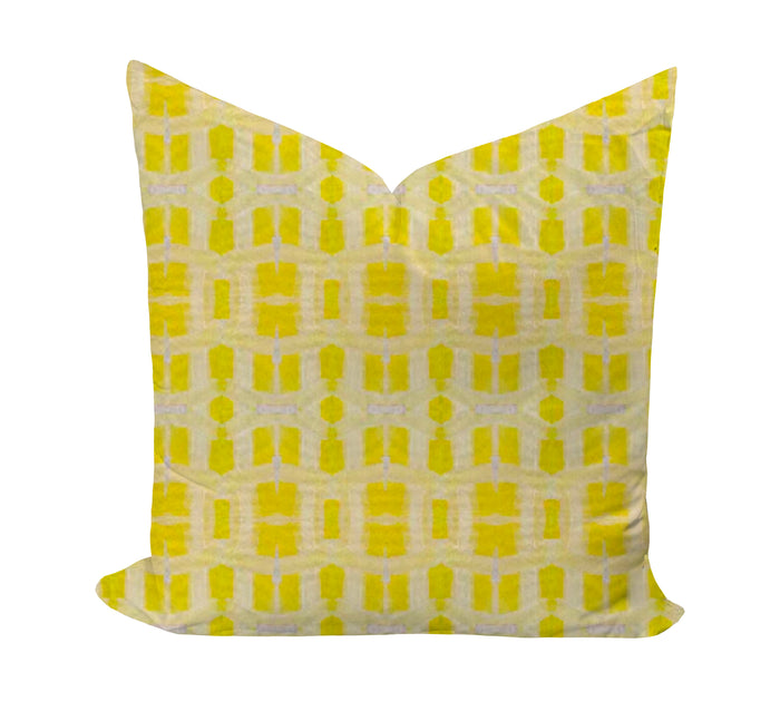 Yellow geometric patterned pillow on a white background