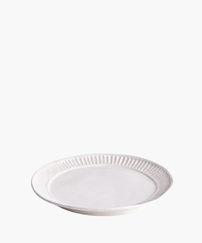 White ceramic plate with decorative rim on a white background