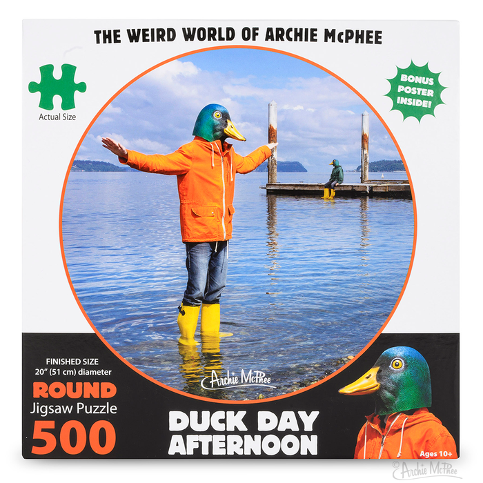 Dive into the peaceful atmosphere of the Duck Day Afternoon Puzzle, a 500-piece challenge showcasing an individual in an orange coat and duck mask, arms outstretched in water, set against a tranquil lake backdrop. Ideal for relaxation and stress relief, this puzzle perfectly balances challenge with serenity.