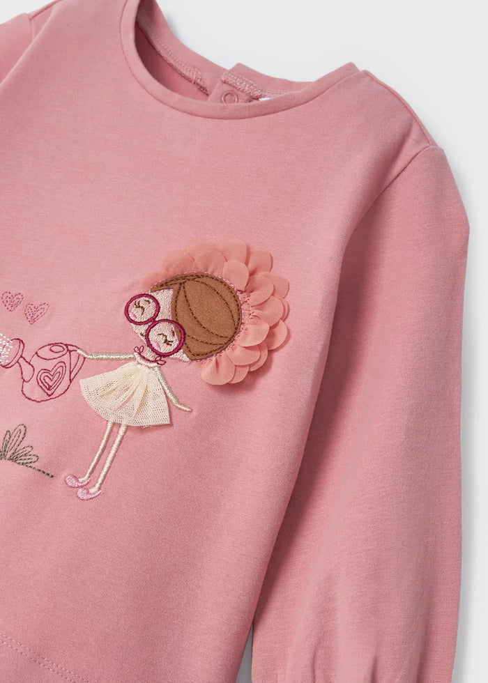 Closeup of Mayoral baby girl embroidered top showing front graphics and Pink cotton fabric.