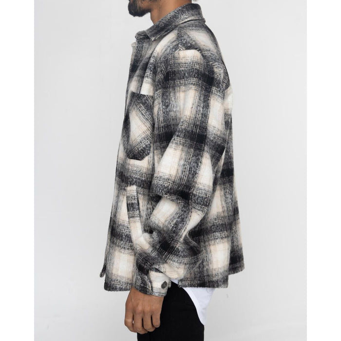Men's black and white EPTM Slit Flannel Button Up with front pockets and slit hem detailing