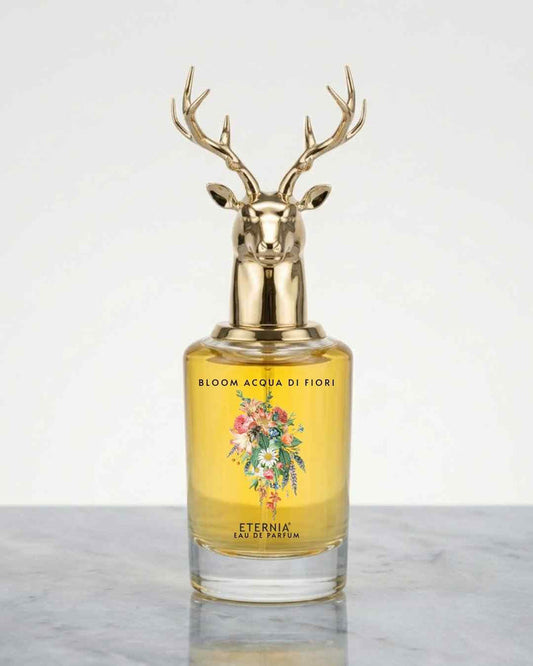 Eternia eau de parfum bottle with gold deer-antler cap and yellow floral liquid