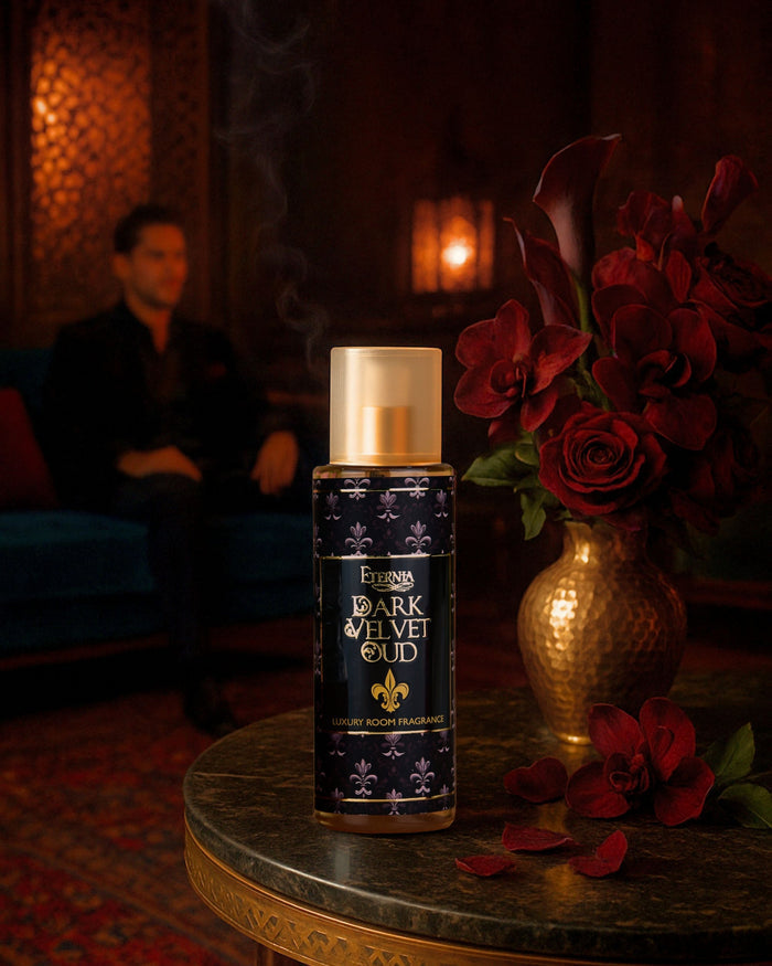 Eternia® Dark Velvet Oud room spray bottle on round tabletop with gold cap and ornate label.