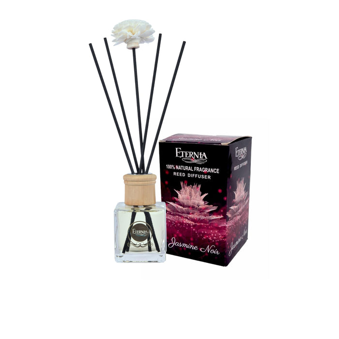 Glass reed diffuser bottle with black reeds and a flower topper, with diffuser box