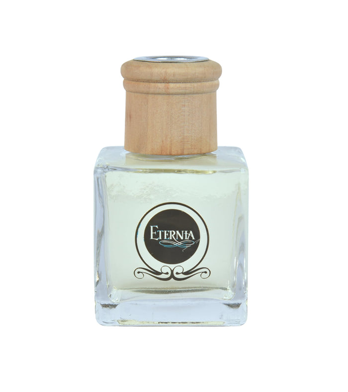 Clear glass reed diffuser bottle with rattan cap and Eternia logo label