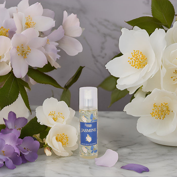 Eternia Jasmine room spray bottle with white pump surrounded by white blossoms