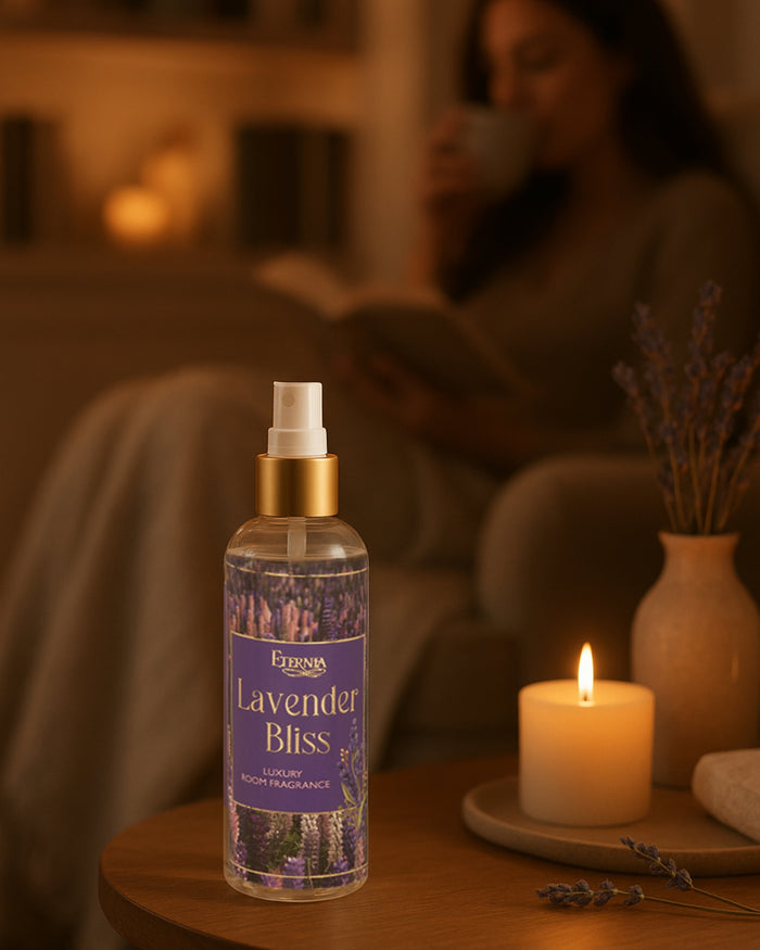 Lavender Bliss room spray with white spray pump, purple label beside candle