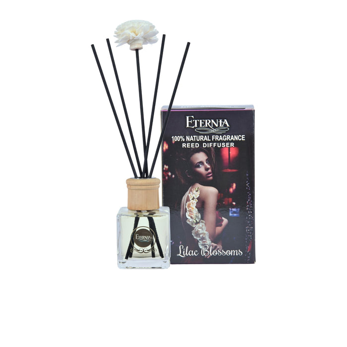 Clear reed diffuser bottle with black rattan sticks and Lilac Blossoms product box