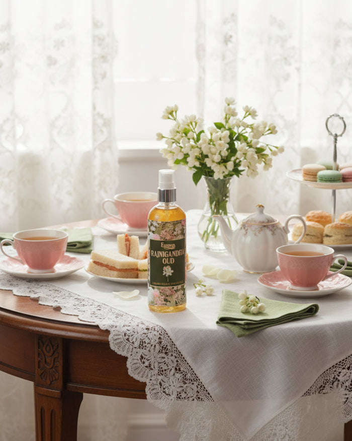 Room spray bottle with amber liquid, white pump, green label and illustrated blooms