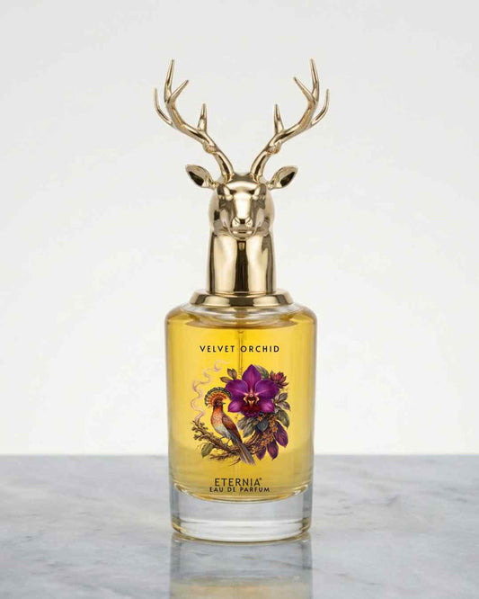 Eternia® Velvet Orchid eau de parfum bottle with gold deer-antler cap, amber liquid