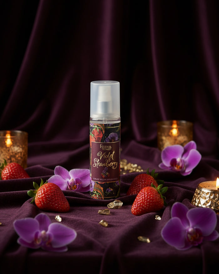 Room spray bottle with white cap, Violet Strawberry label on dark purple fabric