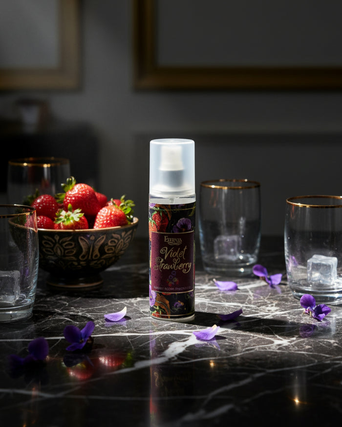 Room spray bottle with white cap and Violet Strawberry label on marble tabletop