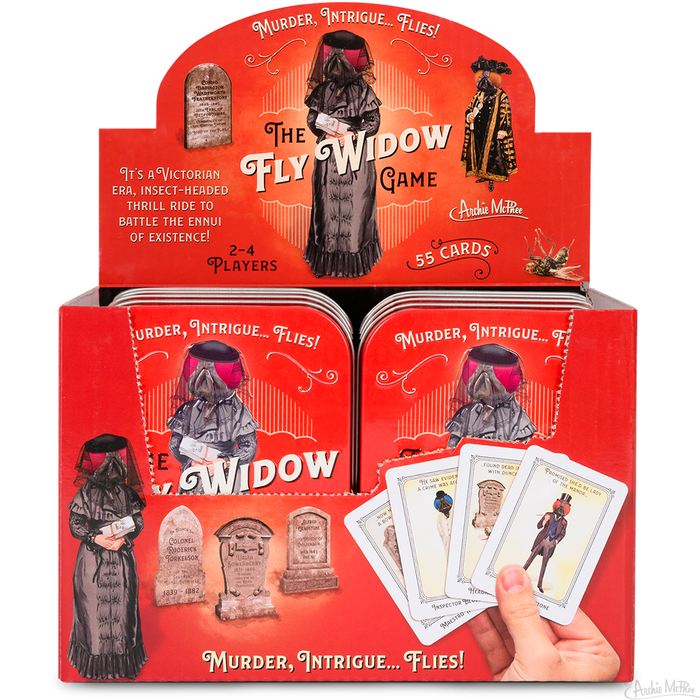 A display box for the Fly Widow Game, inspired by Victorian themes, includes humorously illustrated cards and character art reminiscent of the classic Old Maid game.