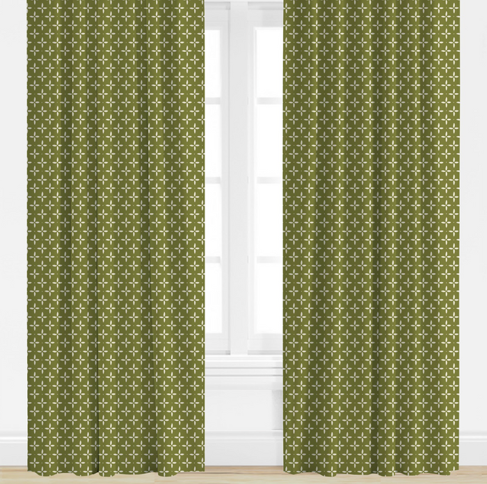 Green, star patterned curtains on a white window background