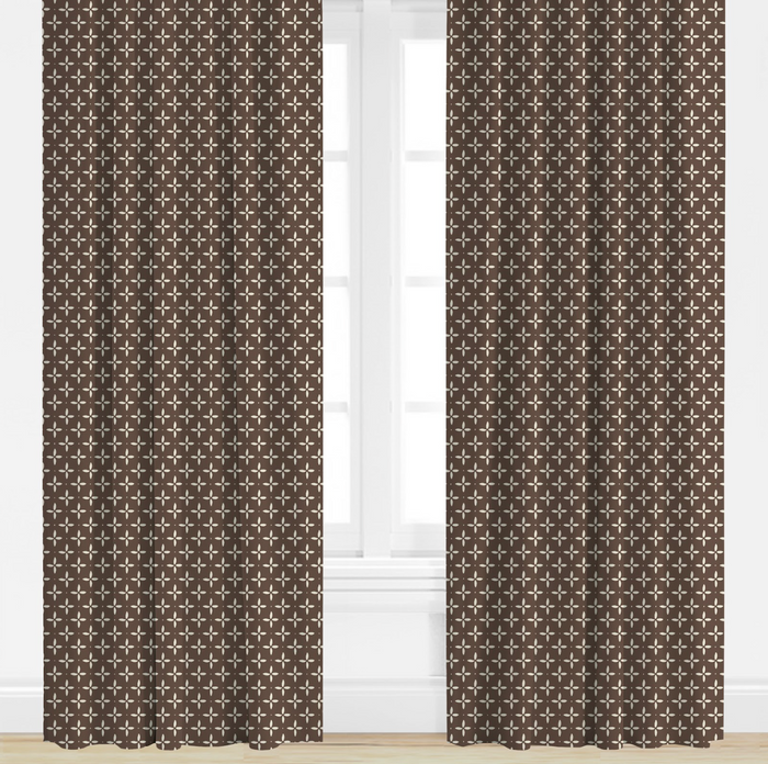 Pair of brown patterned curtains on a white background