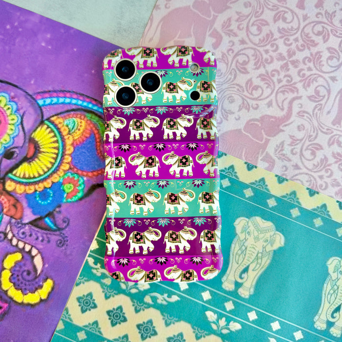 Fortune Parade Wavy Luxe MagSafe iPhone case styled on a teal and purple paisley mandala backdrop, showing the elephant parade print.