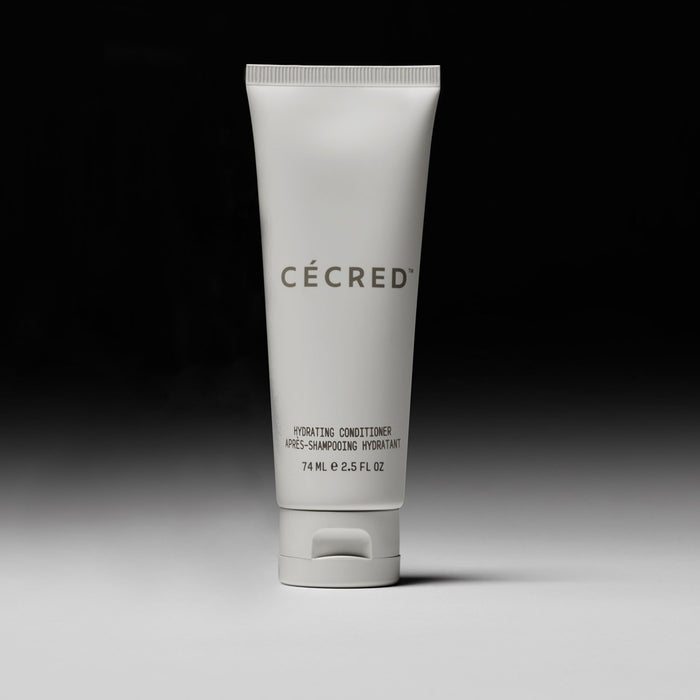 Cécred Hydrating Conditioner travel size 74ml tube displayed upright against a gradient grey background