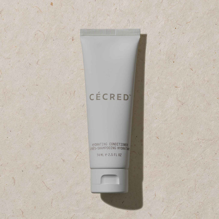 Travel-size Cécred Hydrating Conditioner shown in soft natural light, emphasizing minimalist packaging and smooth matte texture.