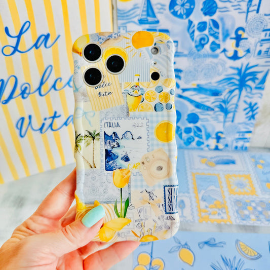 Trendy light yellow and blue wavy iPhone case featuring a Mediterranean collage of lemons, Capri travel stamps, and yellow tulips with a high-gloss finish.