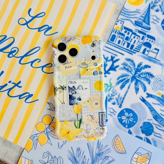 Trendy light yellow and blue wavy iPhone case featuring a Mediterranean collage of lemons, Capri travel stamps, and yellow tulips with a high-gloss finish.