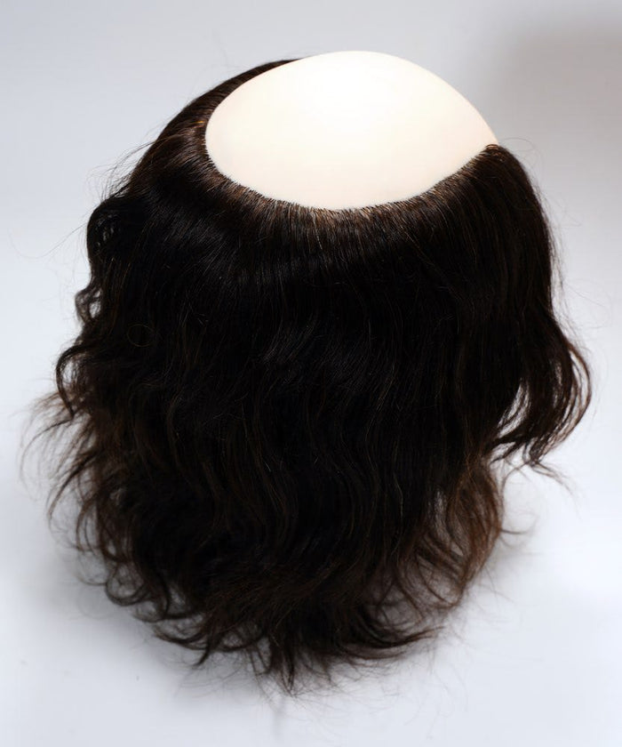 The Perfect Locks Male Wavy Human Hair Mannequin Head features dark brown wavy hair and a smooth beige scalp on a white background.