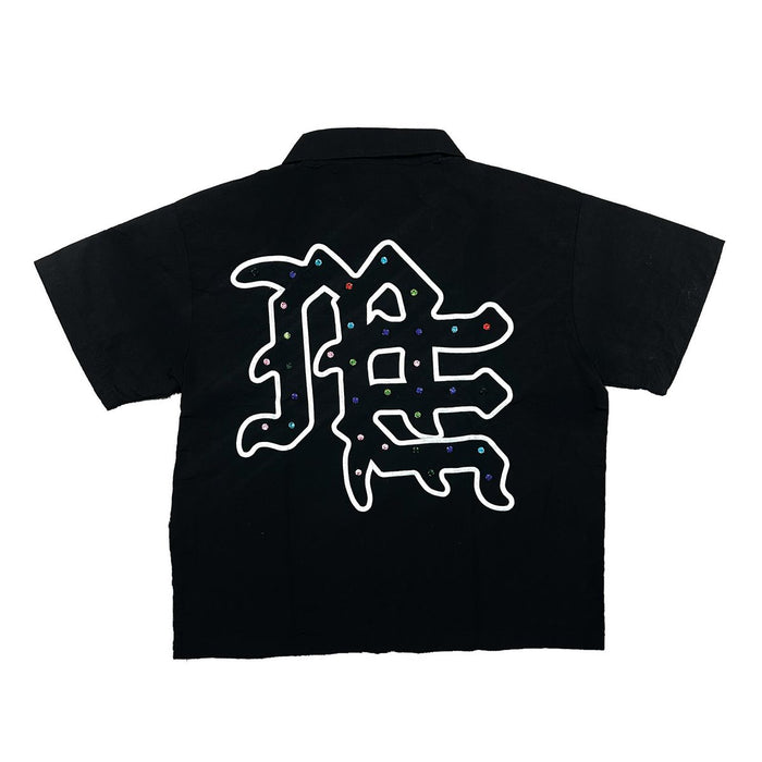 Close-up of the Me rhinestone design on the black zip-up shirt, highlighting its sparkling details and trendy style