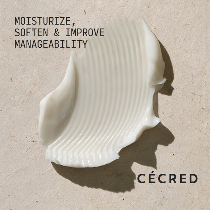 Cécred Moisturizing Deep Conditioner creamy white formula swatch with Moisturize, Soften & Improve Manageability claim text against a warm neutral textured background
