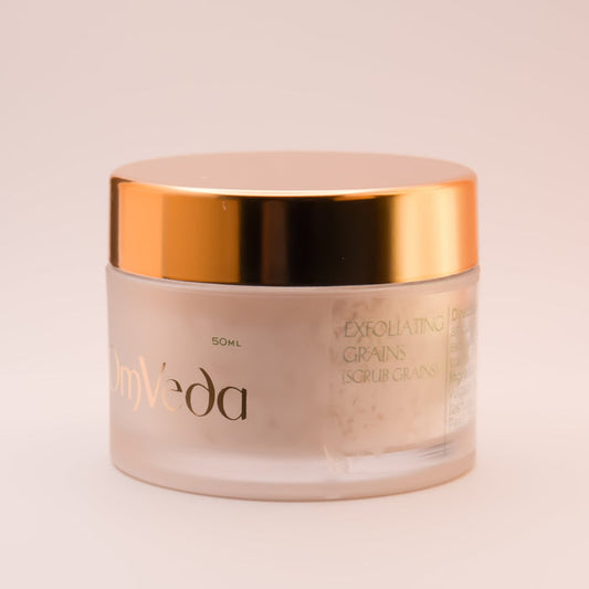 OmVeda exfoliating grains jar with gold lid and label text, 50 ml