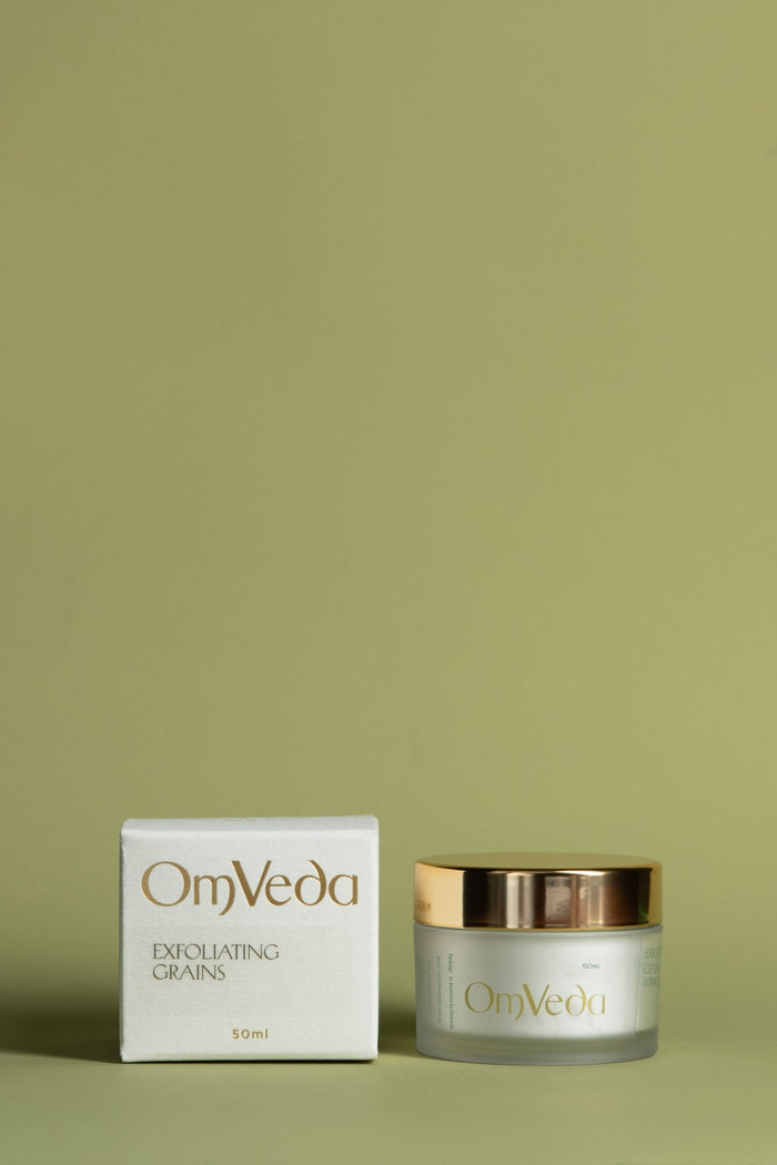 OmVeda exfoliating grains jar with gold lid, 50 ml, shown with product box