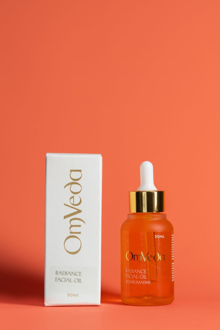 OmVeda Radiance Kumkumadi Facial Oil 50ml, amber glass dropper bottle and white box.