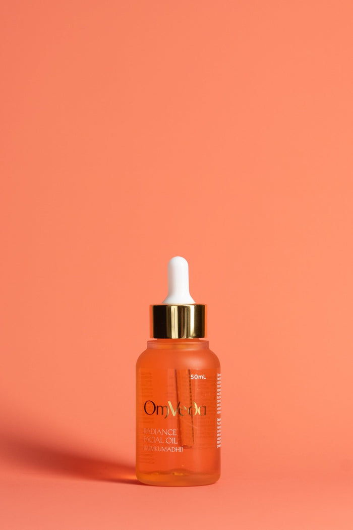 OmVeda Radiance Kumkumadi Facial Oil 50ml, amber dropper bottle with gold cap.