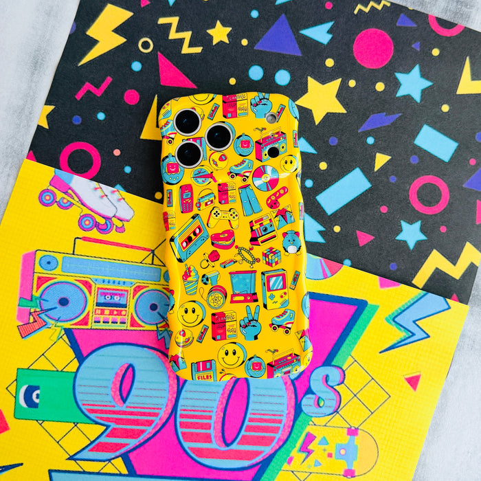Oops, It's the 90's Wavy Luxe MagSafe iPhone case styled on a neon Memphis-pattern backdrop with a 90s sign and roller skate.